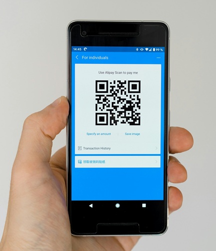 Guest scanning a QR code on a phone for the MemoShot guestbooth upload experience