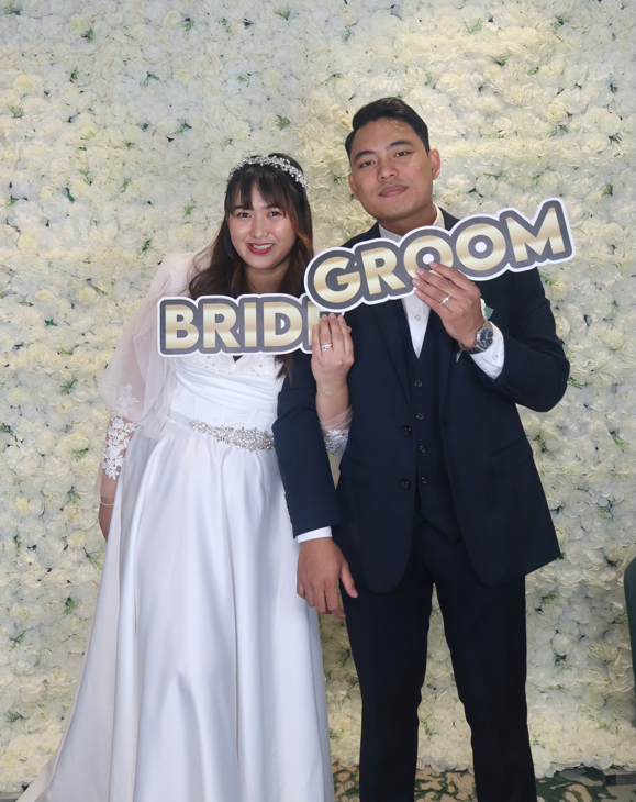 Mirror photobooth bride and groom portrait with signs