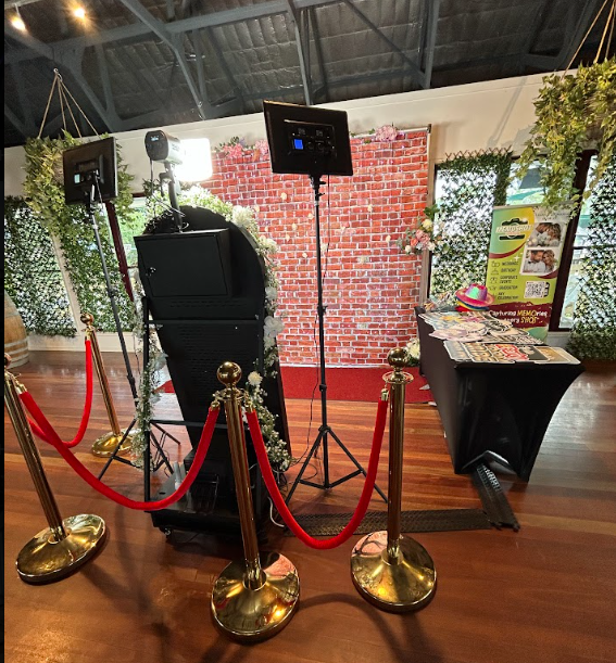 Mirror photobooth event setup with backdrop, props, and red rope styling