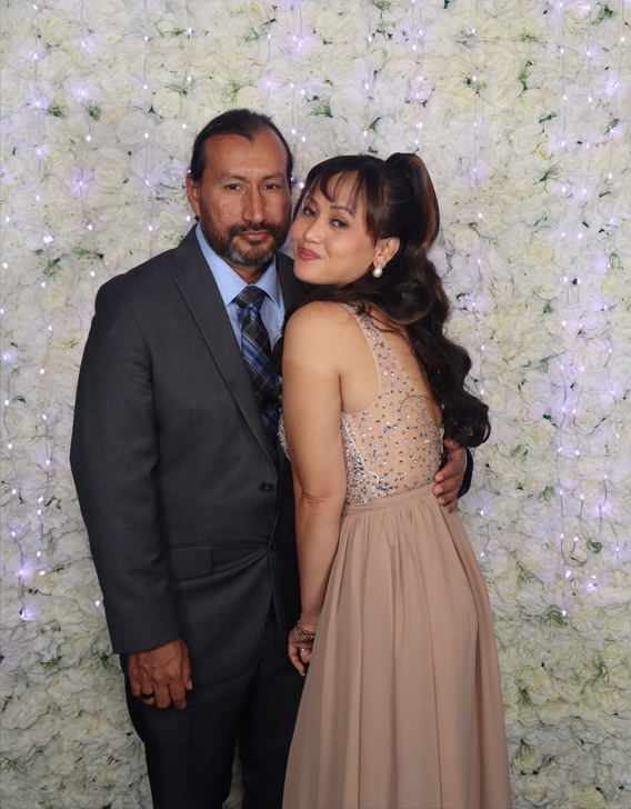 Open air photobooth couple portrait with white flower wall backdrop