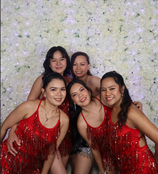 Open air photobooth group portrait with white flower wall backdrop